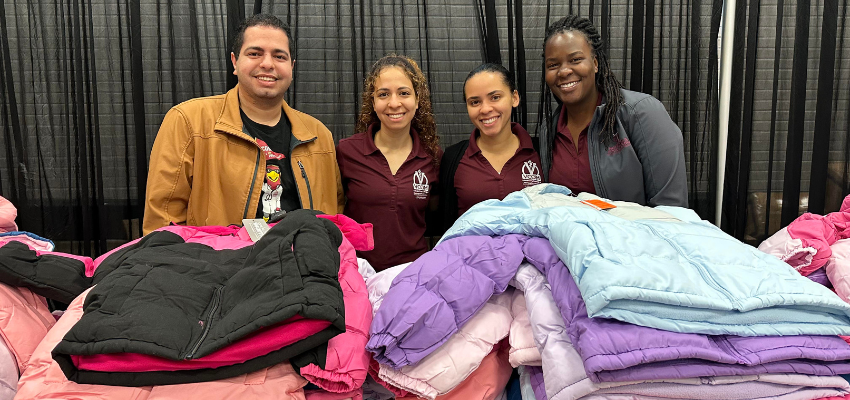 Students smiling with children's coats
