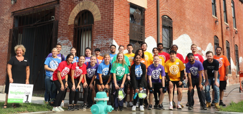 MUCOM Students pose in front of Aspire House