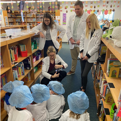 Students teaching children