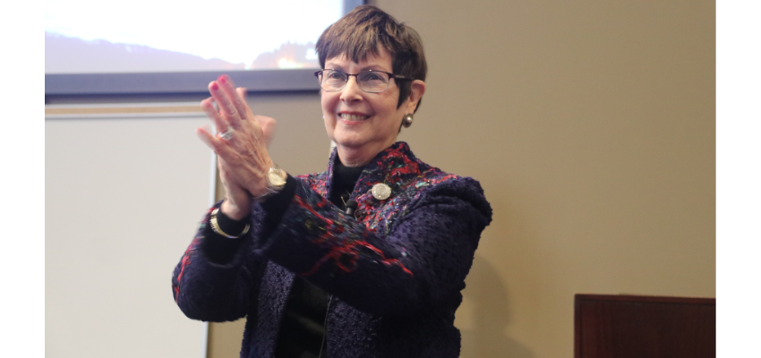 Karen Nichols claps during the conference