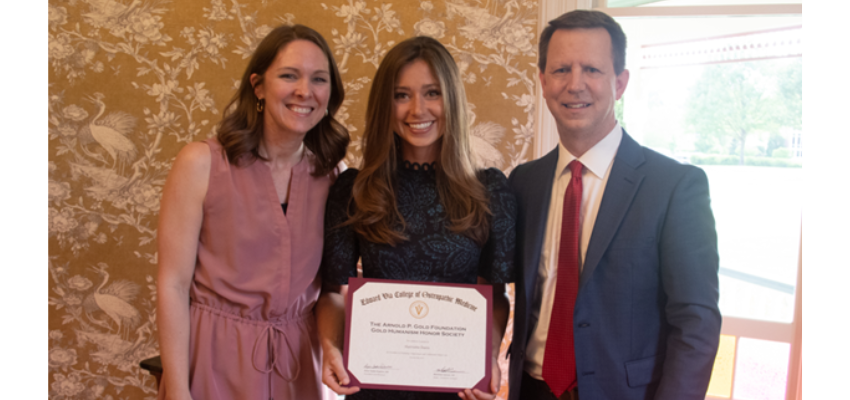 Harriette holds certificate for Arnold P. Gold foundation.