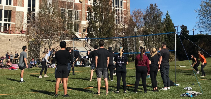 VCOM students play volleyball outside
