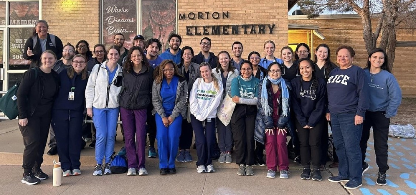 Students pose in front of rural elementary school