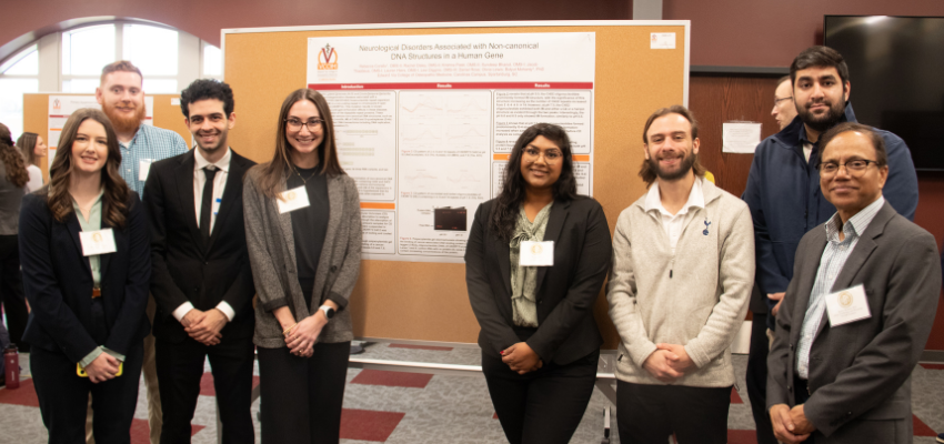 Students standing in front of a poster hall