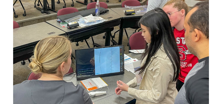 Students learning to use radiology device