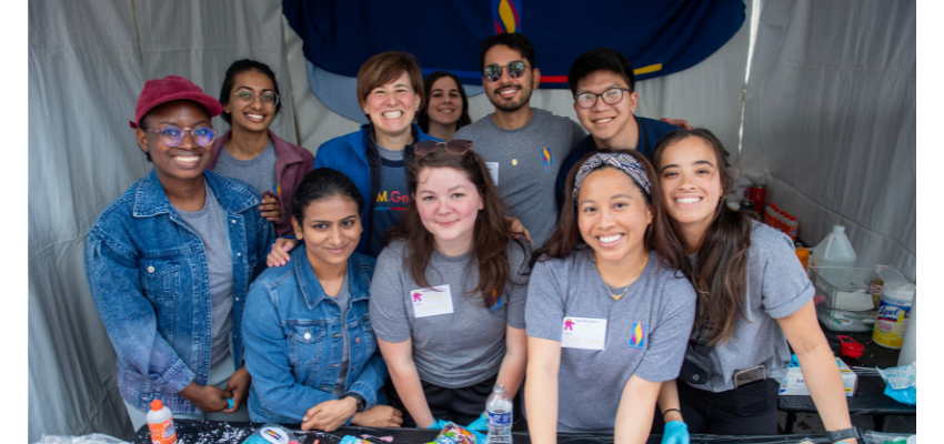 Andrea Mann, DO, and students smiling in PCOM tent.
