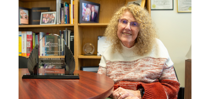 Dr. Wagner sits in her office with her award.