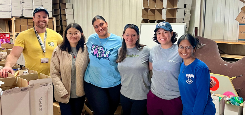 Six students help pack boxes with household essentials