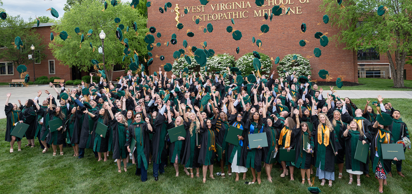 Students throwing their caps into the air