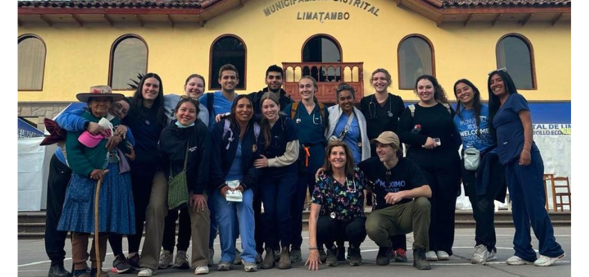 A group of medical students from TouroCOM posing together outside a hospital in Lima, Peru, during a medical outreach program.