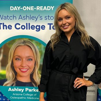 Medical student standing in front of a poster featuring her photo and the title