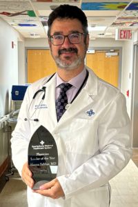 A physician holds a
