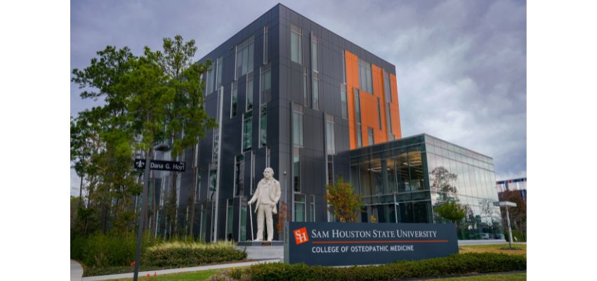 The exterior of the Sam Houston State University College of Osteopathic Medicine, featuring its modern building and the iconic statue of General Sam Houston.