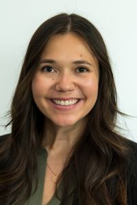 A woman smiles in a professional headshot against a light background.