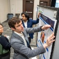 Studentsandfacultymembersreviewandmountresearchpostersduringaposterpresentationevent