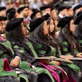 Medicalstudentsseatedinacademicregalialistenattentivelyduringacommencementceremony