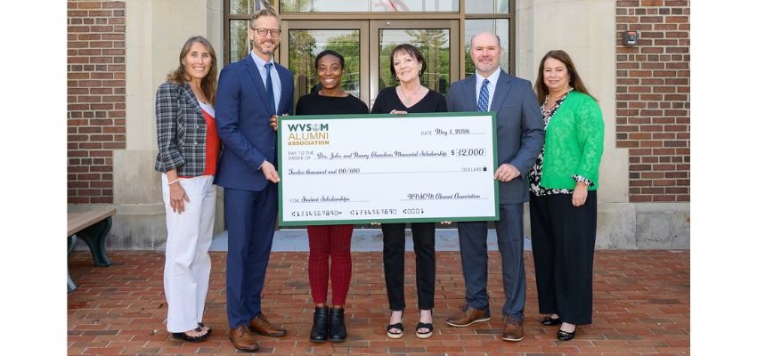 Representatives of the WVSOM Alumni Association present a scholarship award check during a recognition ceremony.