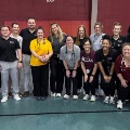 Agroupofmedicalstudentsfacultyandstaffposetogetherinagymnasiumduringacommunityorcampuswellnessevent