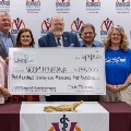 CommunityandinstitutionalleadersposewithaceremonialcheckrecognizingfundingsupportforVCOM-Louisianaduringapresentationevent