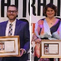Twoawardrecipientsholdframedrecognitionswhileposingonstageduringanhonorsoralumniawardsceremony