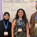 Threeresearchersstandinfrontofascientificposterpresentationduringamedicalresearchconference
