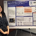 AmedicalstudentstandsbesidearesearchposterontheearlydetectionofParkinsonsdiseaseusingiPad-basedeyetrackingduringascientificconference