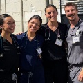 Fourmedicalstudentswearingscrubsandstethoscopesposetogetherduringaninternationalclinicalorservicelearningexperience