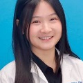 Professionalheadshotofamedicalstudentwearingawhitecoatagainstabluestudiobackground