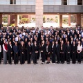 LargegroupofCHSU-COMstudentsdressedinprofessionalattireposingoutsidethecollegebuilding