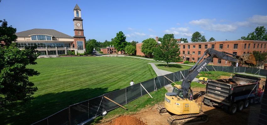 Construction equipment works beside the WVSOM campus lawn as building improvements or expansion projects take place.