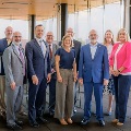 KansasCityUniversityleadersandguestsposeforagroupphotoduringameetingorpartnershipevent
