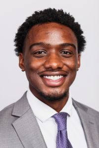 Portrait of a smiling PCOM South Georgia student or faculty member wearing a gray suit and purple tie.
