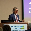 ManspeakingandsmilingatapodiumduringanAACOMpresentationatCommonwealthHealthRegionalHospitalofScranton