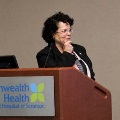WomanspeakingatapodiumandgesturingtowardtheaudienceatCommonwealthHealthRegionalHospitalofScranton