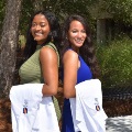 Twomedicalstudentsposeoutdoorsholdingtheirnewwhitecoats