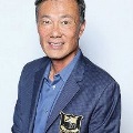Portraitofasmilingmanwearingabluecollaredshirtanddarkblazer