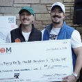 Twomenholdaceremonialcheckfor340185donatedtoTerryReillyHealthServicesduringanICOMcommunityfundraisingevent