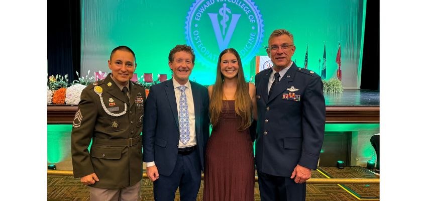 Four people, including two men in military uniforms, pose together at an Edward Via College of Osteopathic Medicine event.