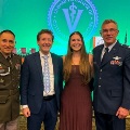 FourpeopleincludingtwomeninmilitaryuniformsposetogetheratanEdwardViaCollegeofOsteopathicMedicineevent