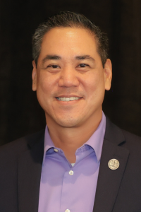 Professional headshot of David Kuo, DO, wearing a blazer and smiling