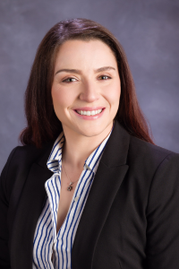 Dr. Thor smiles in a blazer for a professional headshot.
