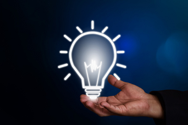 hand holding drawing of lightbulb