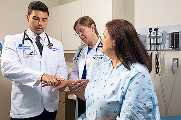Medical Student and instructor treating a patient