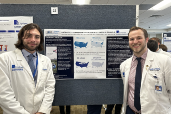At ACOM's Research Day, Dr. Adkins' co-investigators pose with their poster on antimicrobial stewardship .