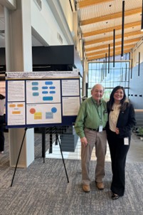 Dr. Bell and Negia presenting their literature review at MCOM Spring Research Day 2025