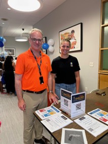 Erik and PCOM student sharing resources for the SHELTER Program.