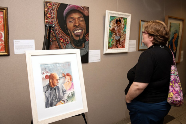 Community members engaging with the Soul Shots portraits.