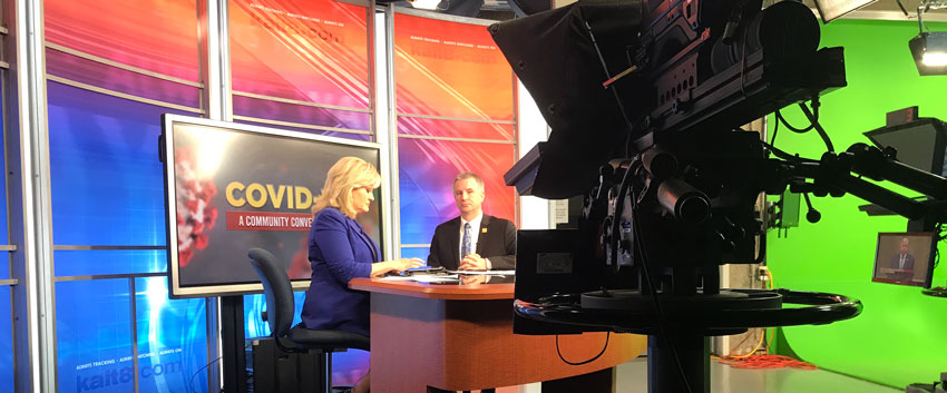 Two NYITCOM staff report on Covid-19 in a TV studio