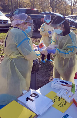 NYITCOM volunteers processing a COVID-19 testing kit