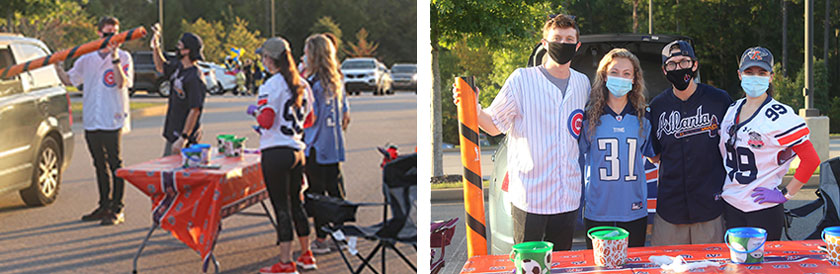 Students giving candy out through a socially distanced tube to families in cars